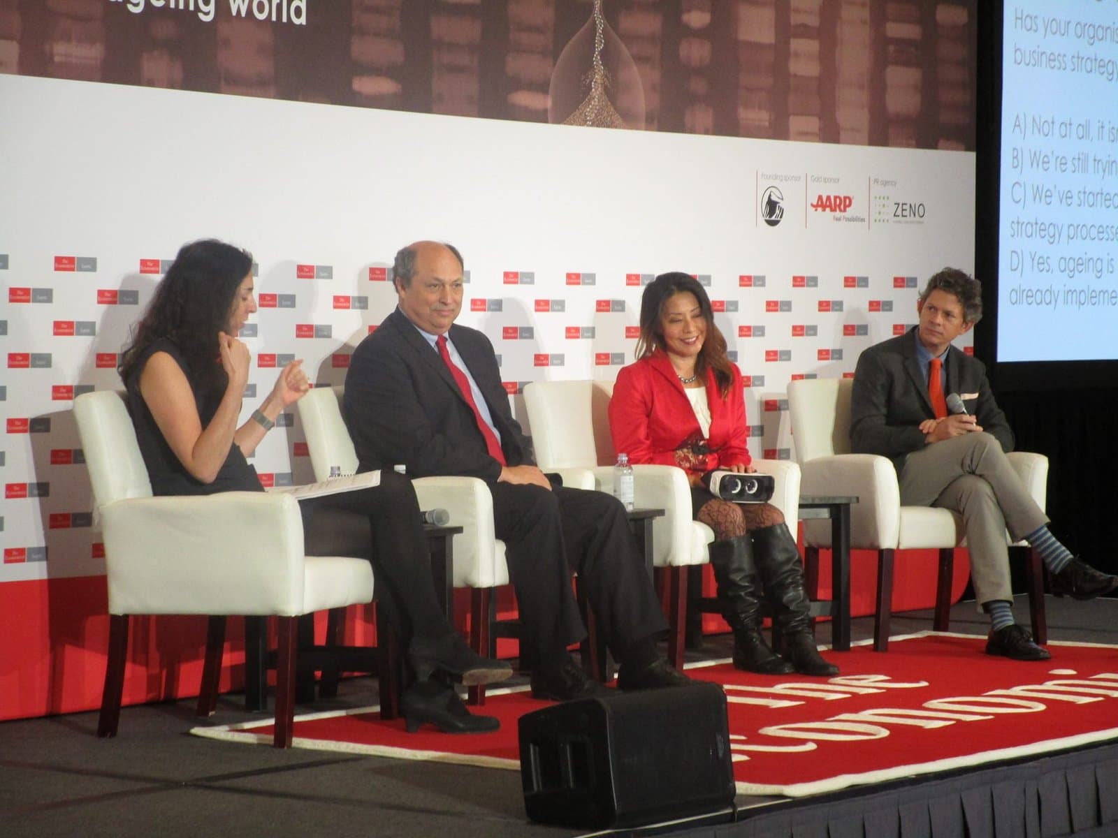 Dr. Sonya Kim speaking on The Economist Business of Longevity panel with a VR headset